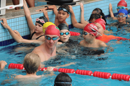 Ben in pool with JB students