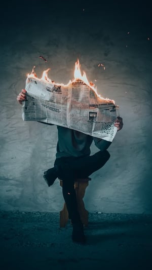 Person reading burning paper