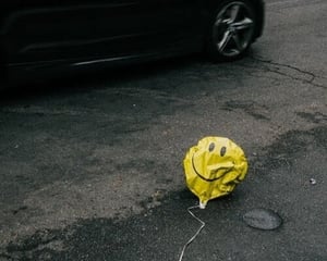 Crumpled balloon on pavement