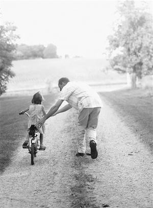 Child learning to ride a bike