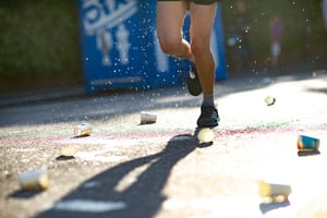 Marathon runners feet among discarded cups